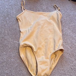 Hi! This is a yellow leotard with a wide open back.